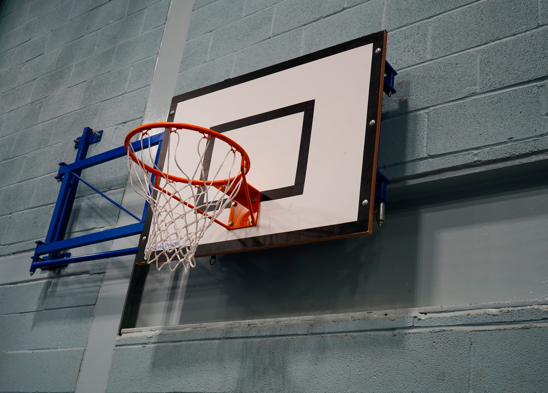 Looking up at a basketball hoop and backboard